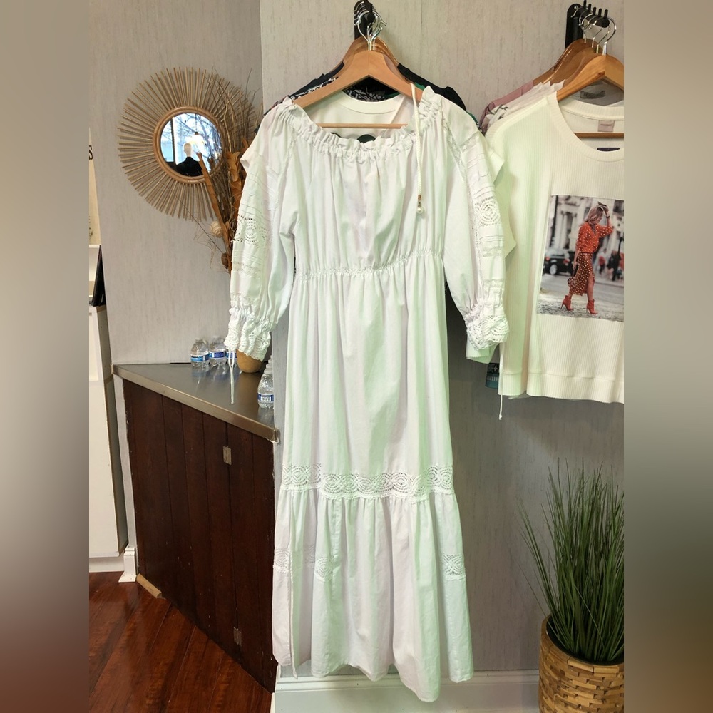 White dress with embroidered details.